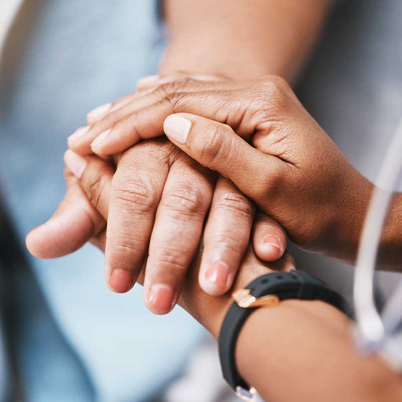 nurse holding hands with patient